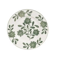 plato de postre de ceramica blanca y flores y hojas verdes