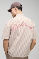 camisa oversize de rayas con bordado worldwide y eslogan beige