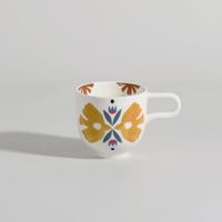 taza de gres blanco y azul con pajaros