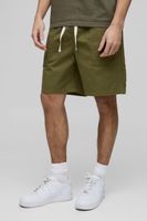 pantalones cortos de sarga elasticos holgados con abertura en el bajo verde
