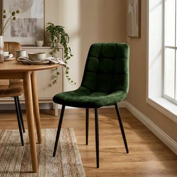 Silla con patas de metal y asiento en terciopelo verde