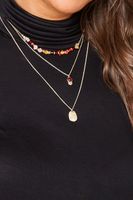 collar dorado de capas con cuentas rojas