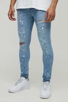 vaqueros super pitillo rotos con salpicaduras de pintura azul
