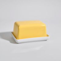 mantequillera de gres amarillo y blanco