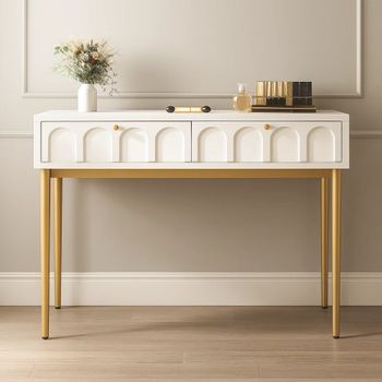 Mesa auxiliar blanca con patas doradas y cajones arqueados.